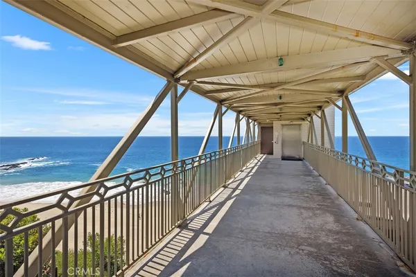 a kitchen with stainless steel appliances kitchen island granite countertop a dining table chairs and white cabinets