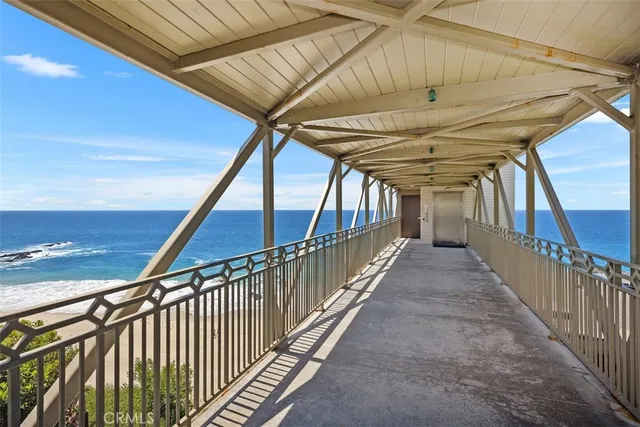 a kitchen with stainless steel appliances kitchen island granite countertop a dining table chairs and white cabinets