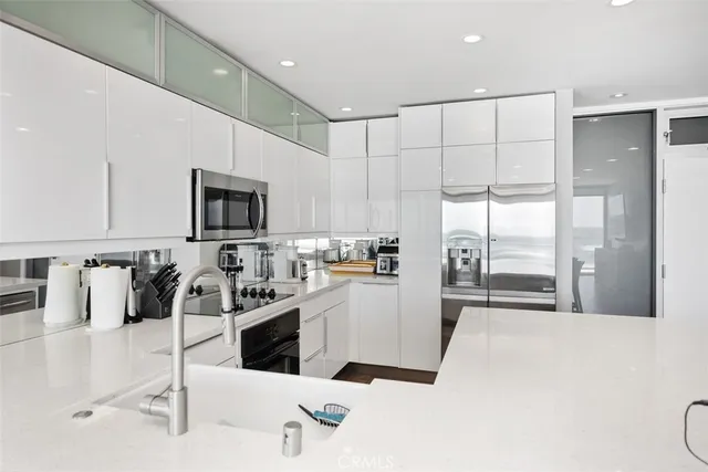 a kitchen with a sink a stove and chairs