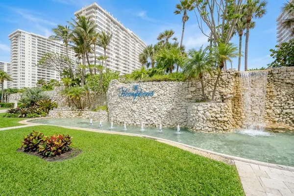 a view of a backyard with plants and large trees
