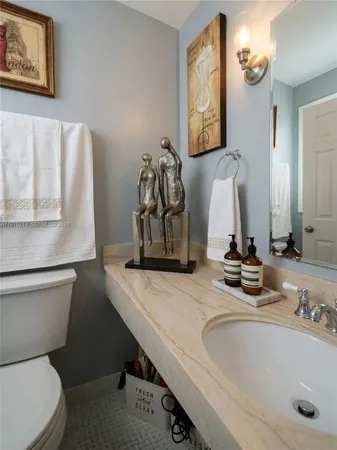 a bathroom with a toilet sink and mirror