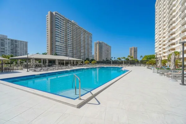 a view of a swimming pool with outdoor seating