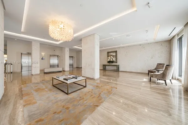 a living room with furniture and a chandelier