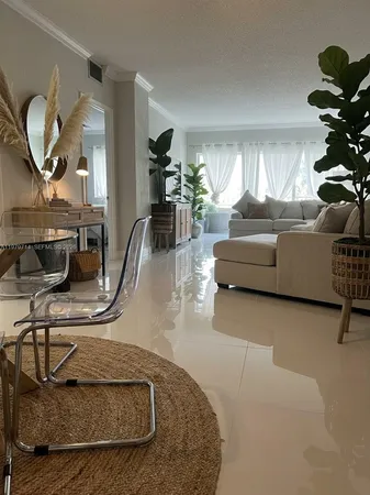 a living room with furniture flowerpot and a window