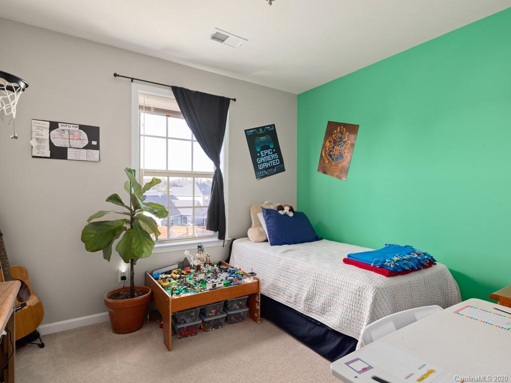 21 North River Road Fletcher, NC 28732 - Photo 14 of 19 a bedroom with a bed potted plant and a window