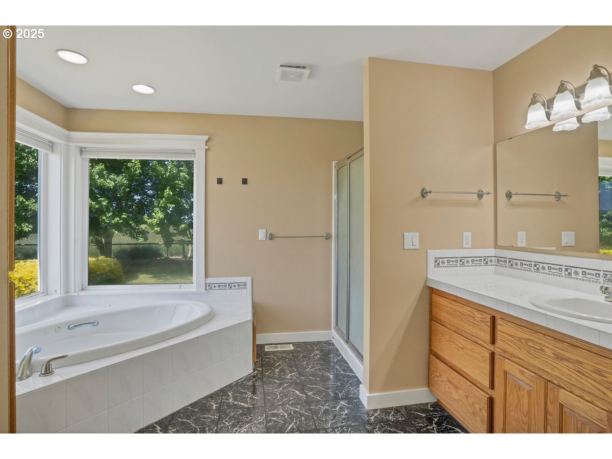 17780 Southeast Wallace Road Dayton, OR 97114 - Photo 13 of 26 a bathroom with a tub a sink and a large mirror