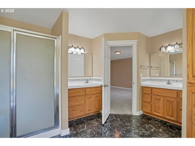 a bathroom with a granite countertop sink mirror and a bathtub