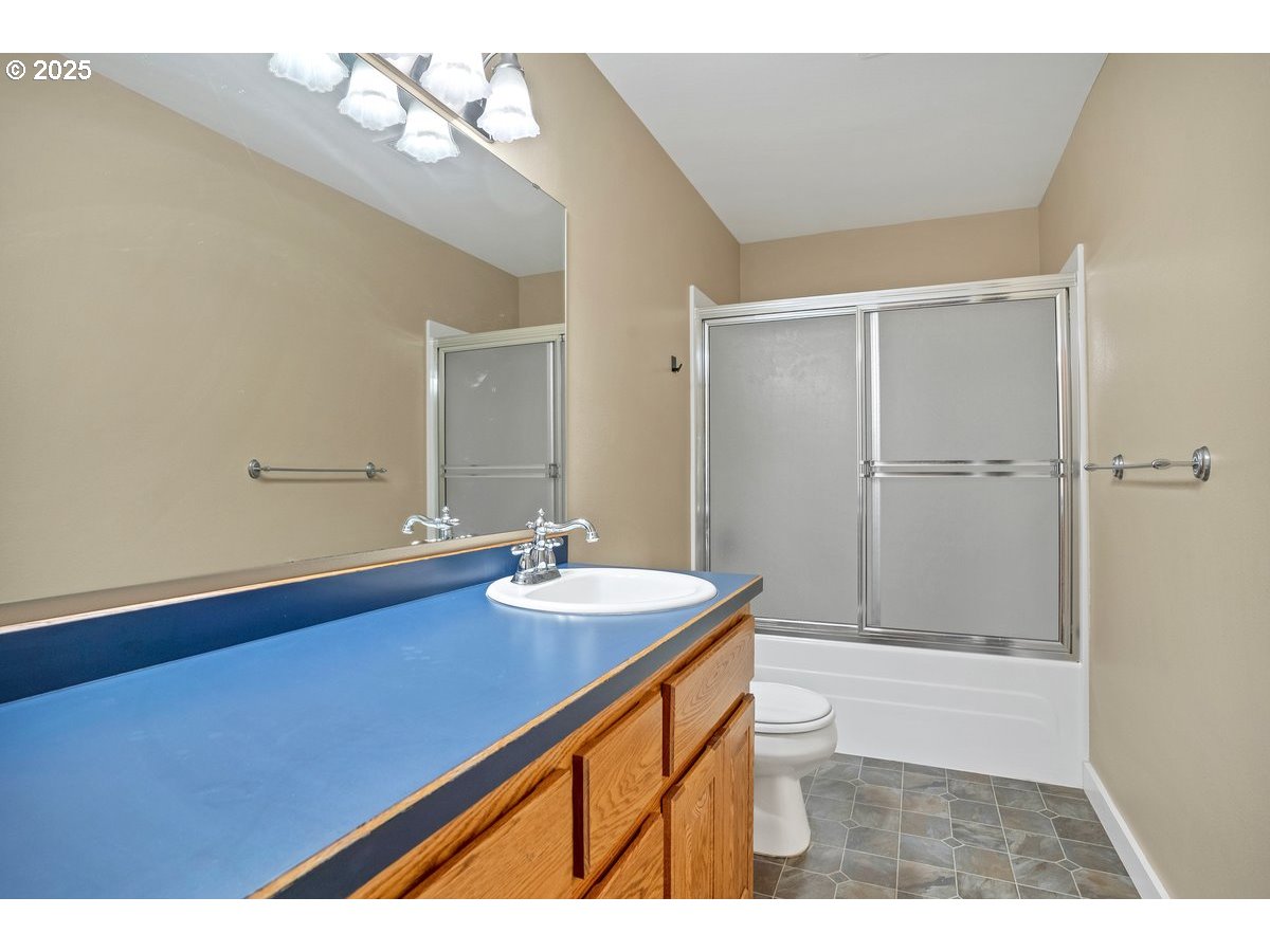 17780 Southeast Wallace Road Dayton, OR 97114 - Photo 17 of 26 a bathroom with a sink a toilet a mirror and shower