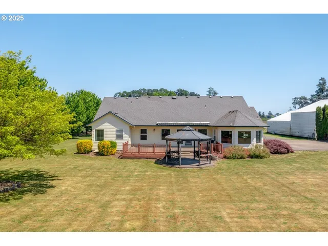 a view of a house with patio next to a yard