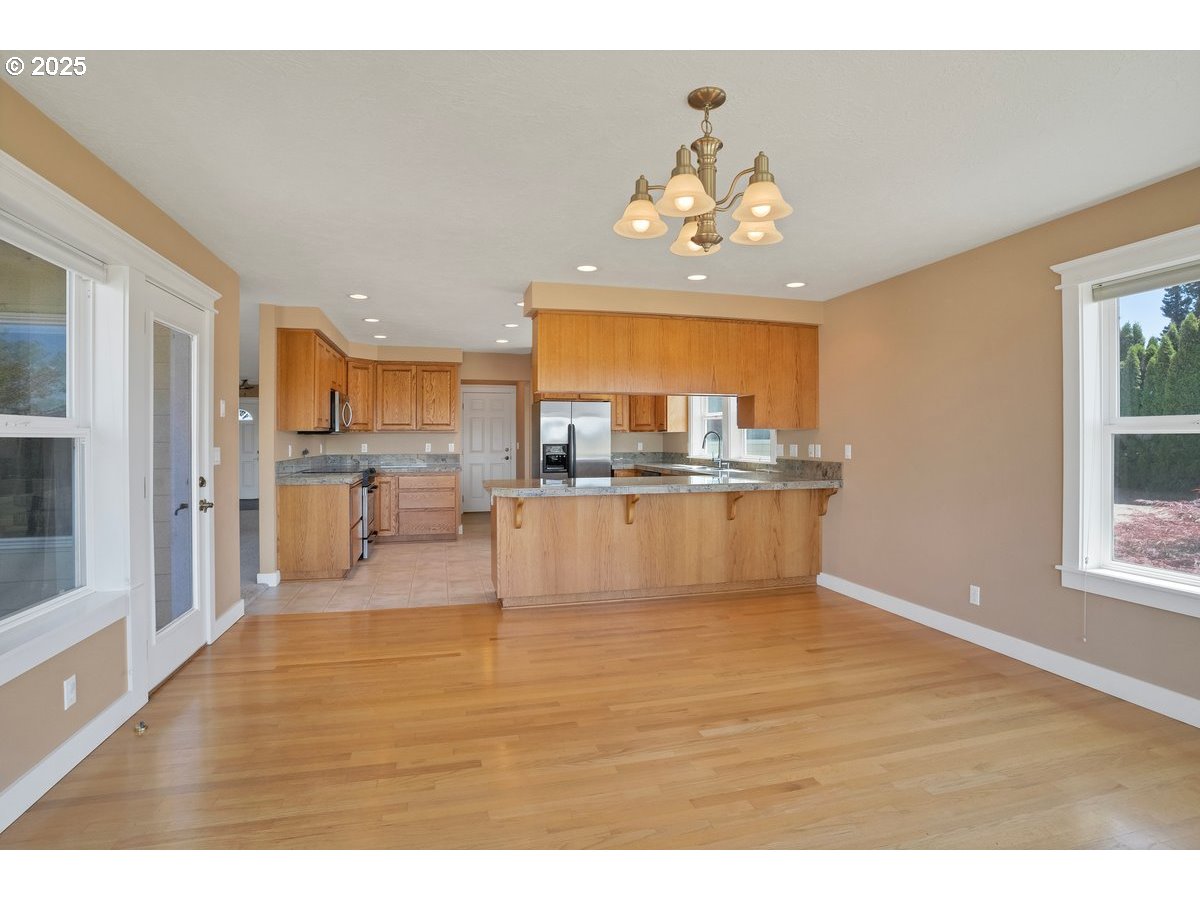 17780 Southeast Wallace Road Dayton, OR 97114 - Photo 10 of 26 a view of a living room and kitchen with kitchen island