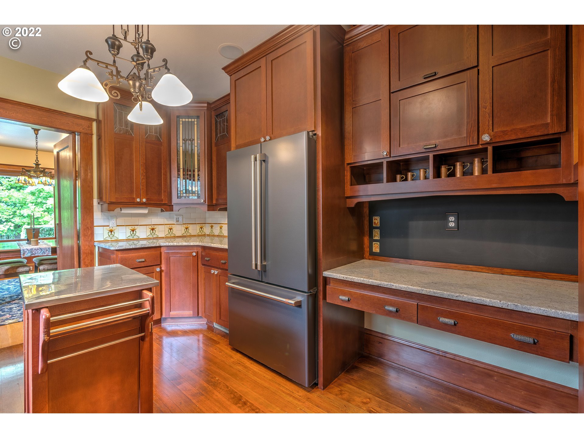 1824 Northeast 53rd Avenue Portland, OR 97213 - Photo 11 of 32 a kitchen with kitchen island granite countertop wooden cabinets and stainless steel appliances