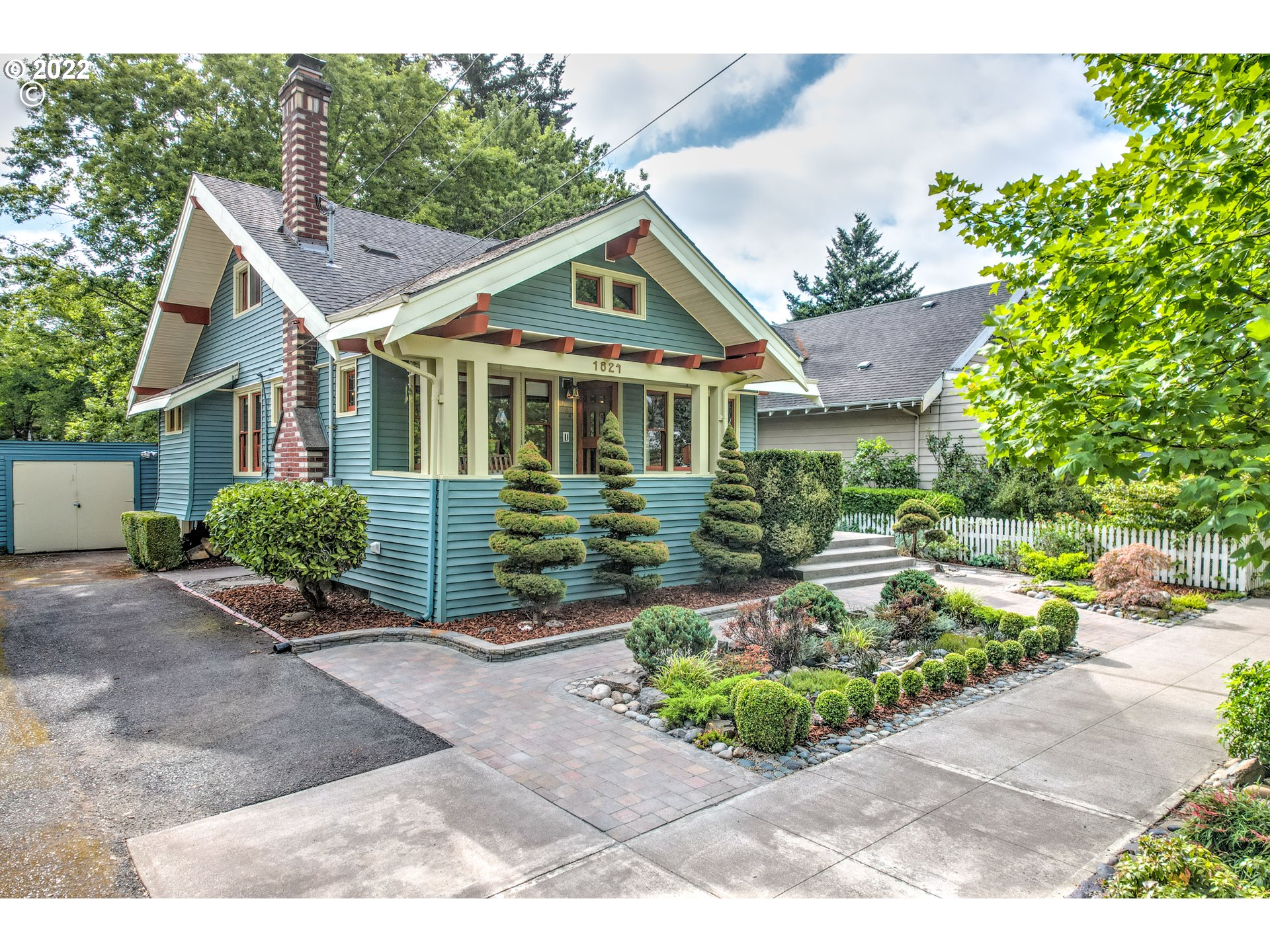 1824 Northeast 53rd Avenue Portland, OR 97213 - Photo 31 of 32 a front view of a house with a yard and potted plants