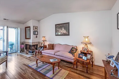 a living room with furniture a fireplace and a table