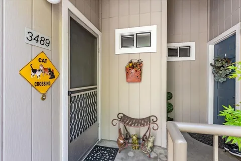 a view of a house with entryway and wooden floor