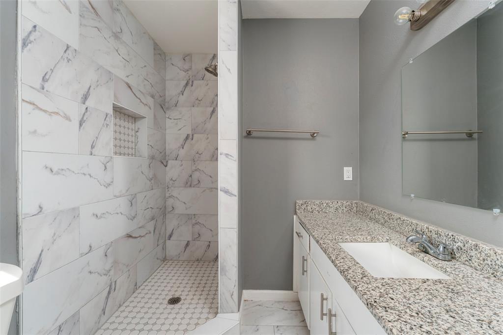 1101 Kennedale Sublett Road Kennedale, TX 76060 - Photo 20 of 35 Walk-in shower with marble-look tile, tiled shower niche, and hex-tile shower floor