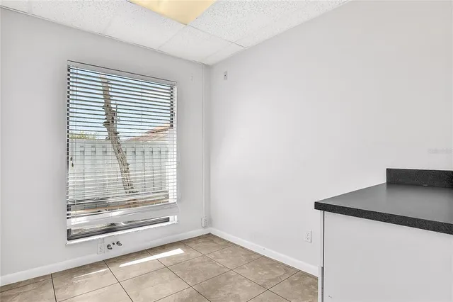 a white kitchen with granite countertop white cabinets and stainless steel appliances