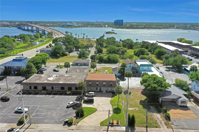 an aerial view of residential houses with outdoor space and swimming pool