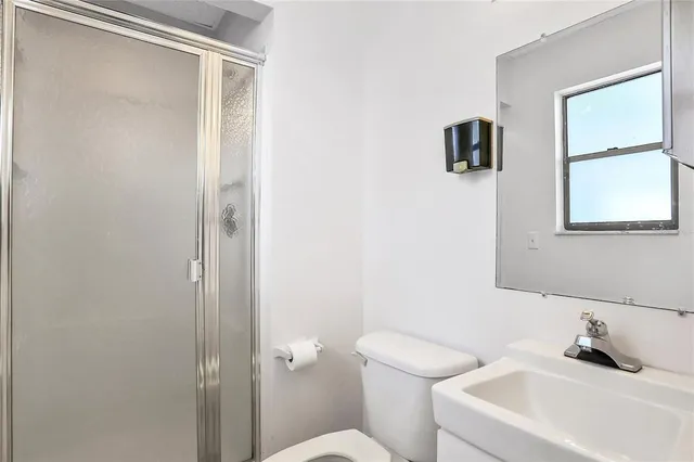 a bathroom with a shower and toilet