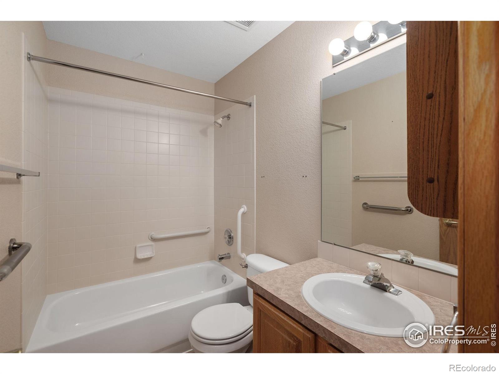 2656 Paddington Road Fort Collins, CO 80525 - Photo 26 of 50 a bathroom with a sink toilet granite tub and shower