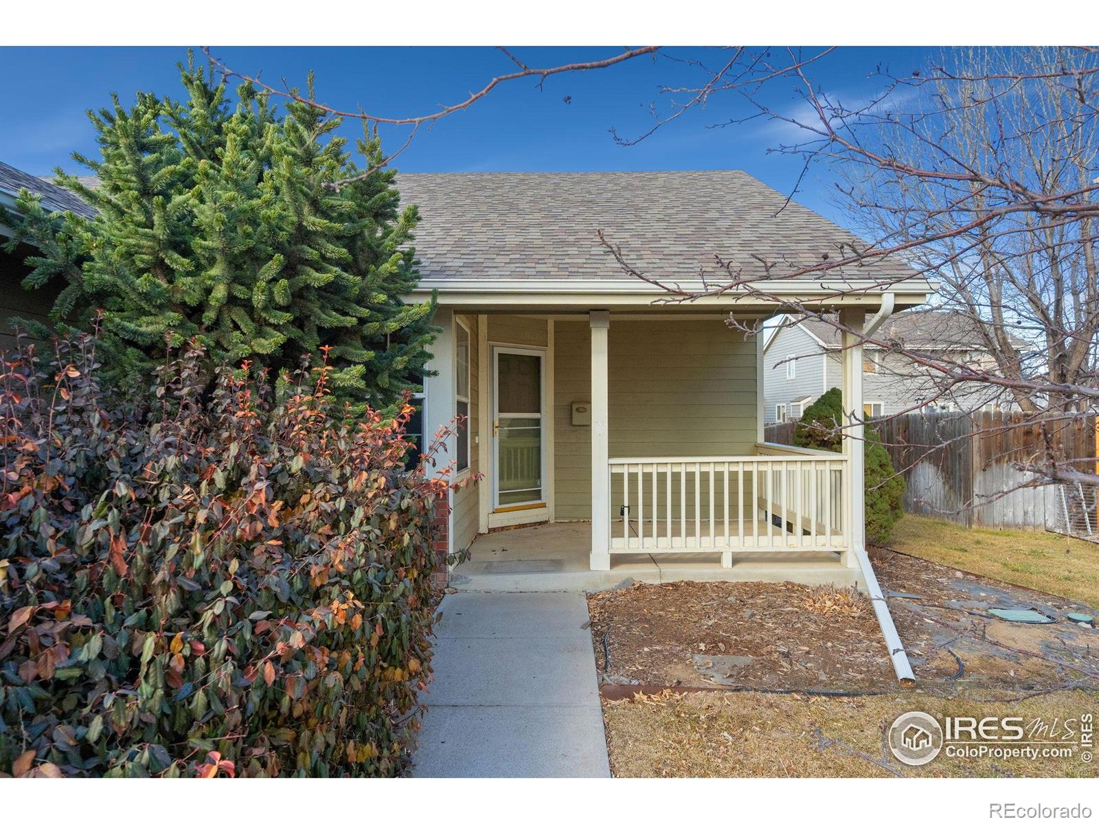 2656 Paddington Road Fort Collins, CO 80525 - Photo 3 of 50 a view of a house with a small yard and wooden fence