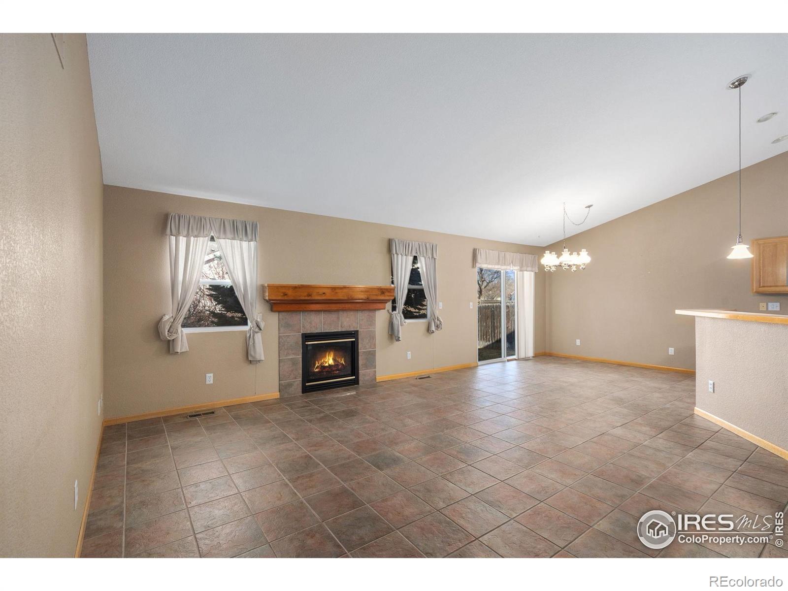 2656 Paddington Road Fort Collins, CO 80525 - Photo 9 of 50 a view of empty room with a fireplace and window