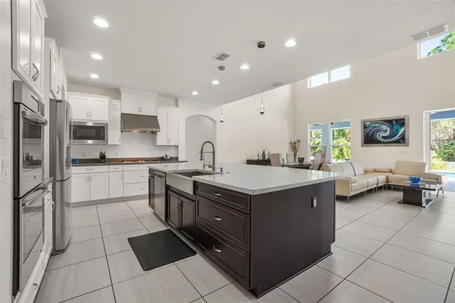 a kitchen with stainless steel appliances granite countertop a sink counter space and cabinets