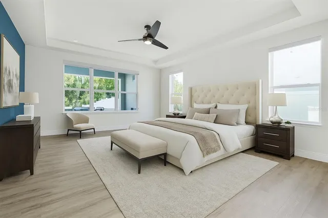 a spacious bedroom with a bed window and a table