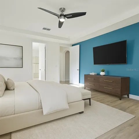 a bedroom with a bed and a flat screen tv