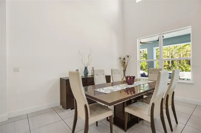a living room with furniture kitchen view and a flat screen tv