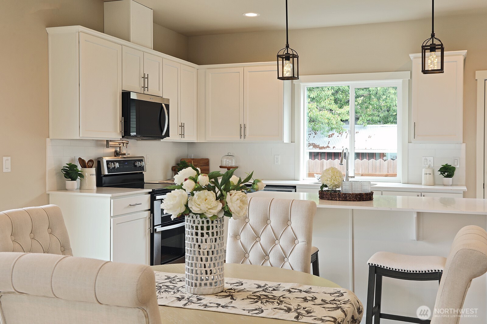 695 3rd Street, Unit A Langley, WA 98260 - Photo 11 of 28 a kitchen with stainless steel appliances kitchen island granite countertop a sink and a white cabinets
