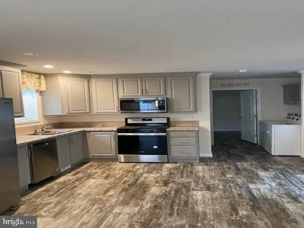 a kitchen with granite countertop a stove and cabinets