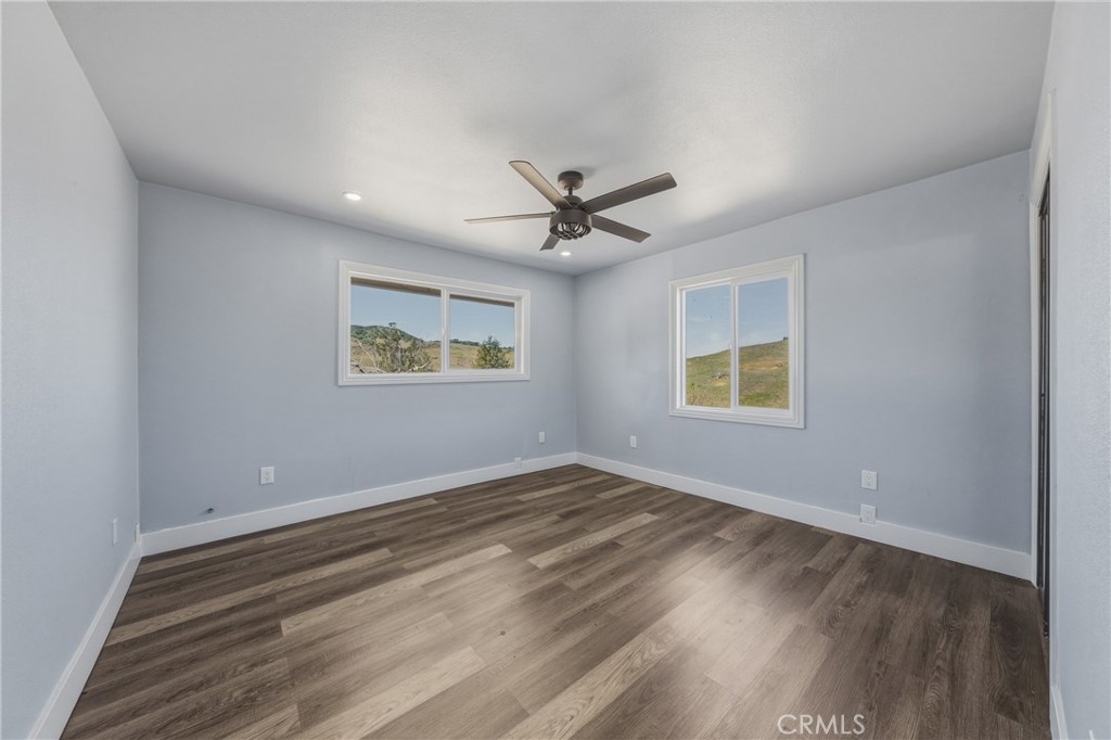 4629 Hill Road Lakeport, CA 95453 - Photo 30 of 69 an empty room with wooden floor and windows