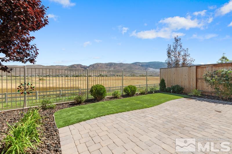 a view of a garden with a building in the background