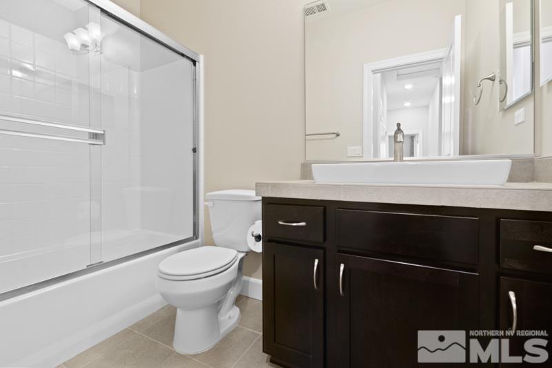 1900 Dark Horse Road, Unit B Reno, NV 89521 - Photo 19 of 34 a bathroom with a sink a toilet a shower and a mirror
