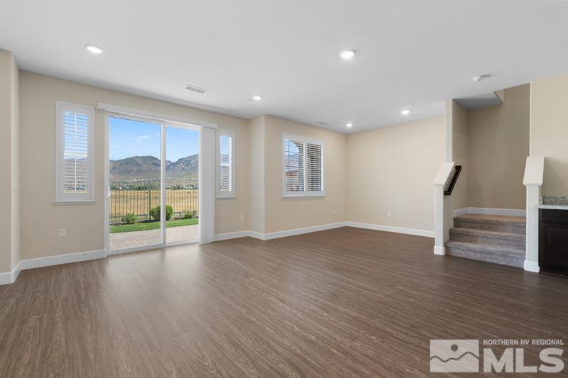 1900 Dark Horse Road, Unit B Reno, NV 89521 - Photo 3 of 34 a view of an empty room with wooden floor and a window