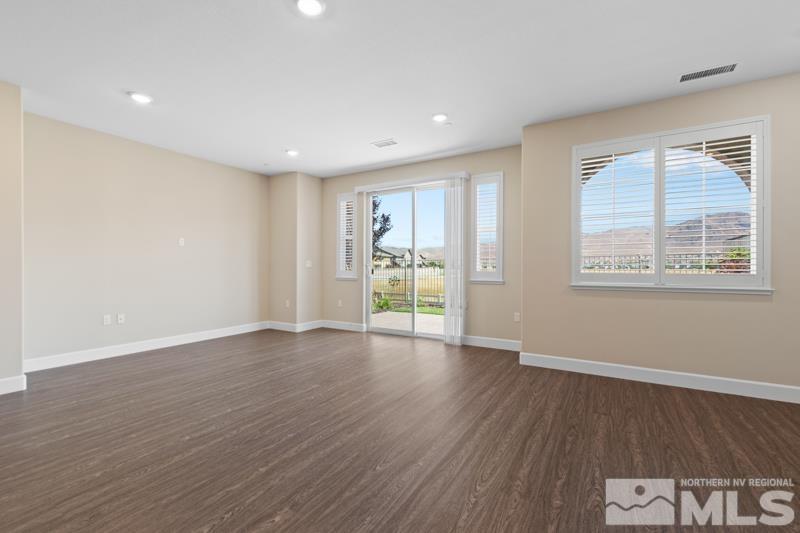 1900 Dark Horse Road, Unit B Reno, NV 89521 - Photo 6 of 34 a view of an empty room with wooden floor and a window