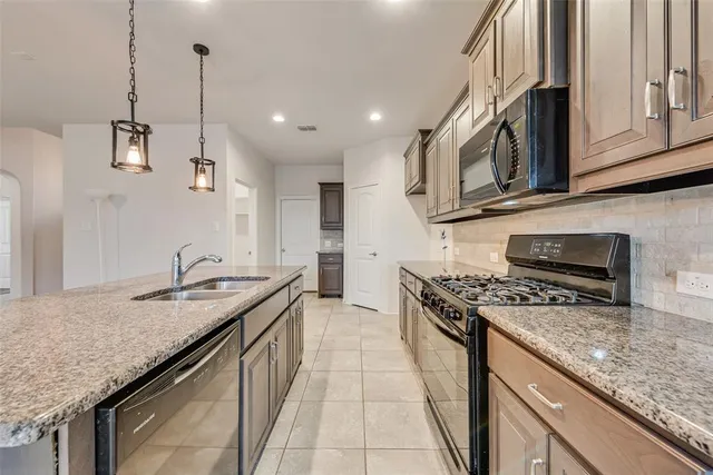 a kitchen that has a lot of cabinets in it