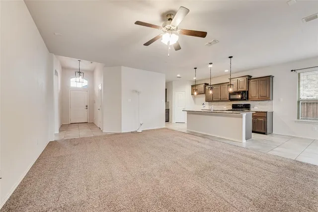 a kitchen with kitchen island granite countertop a sink appliances and cabinets