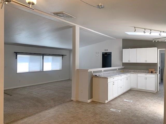 875 20 Road Fruita, CO 81521 - Photo 12 of 40 a kitchen with granite countertop white cabinets and white appliances