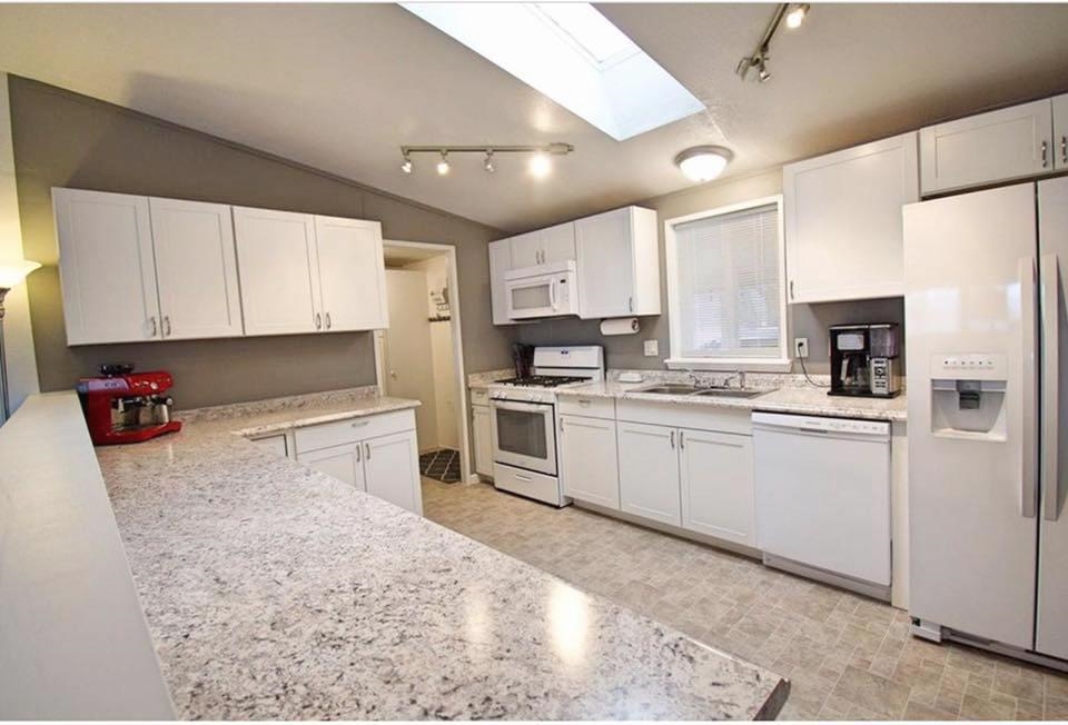 875 20 Road Fruita, CO 81521 - Photo 13 of 40 a kitchen with stainless steel appliances granite countertop a refrigerator sink stove microwave and cabinets