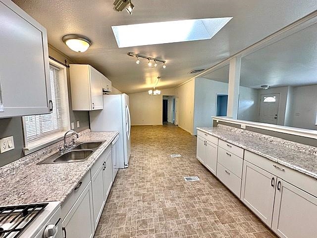 875 20 Road Fruita, CO 81521 - Photo 15 of 40 a large kitchen with granite countertop a sink and cabinets