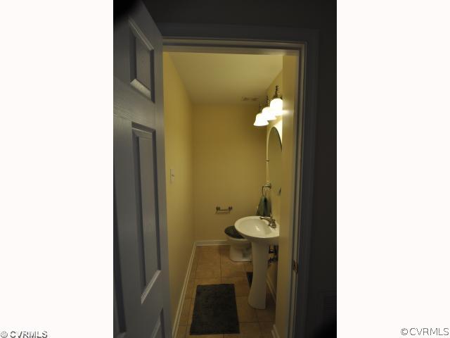13808 Sutters Mill Road Midlothian, VA 23112 - Photo 5 of 12 a view of a bathroom with a sink and mirror