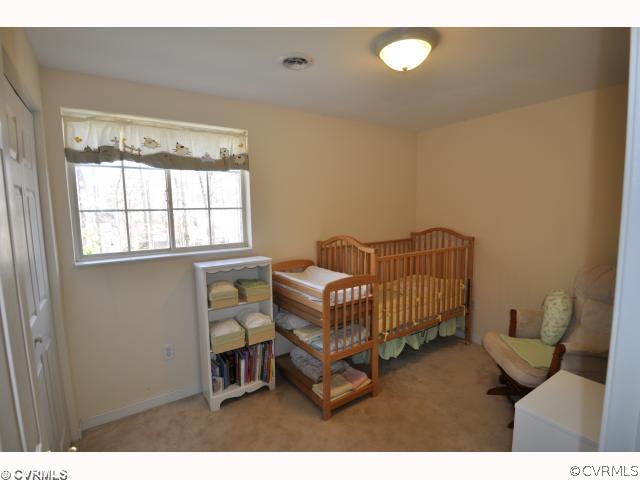 13808 Sutters Mill Road Midlothian, VA 23112 - Photo 8 of 12 a bedroom with a bed and a window
