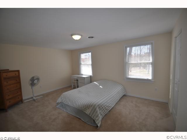 13808 Sutters Mill Road Midlothian, VA 23112 - Photo 9 of 12 a bedroom with a bed and window