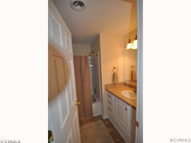 13808 Sutters Mill Road Midlothian, VA 23112 - Photo 10 of 12 a bathroom with a granite countertop sink and shower