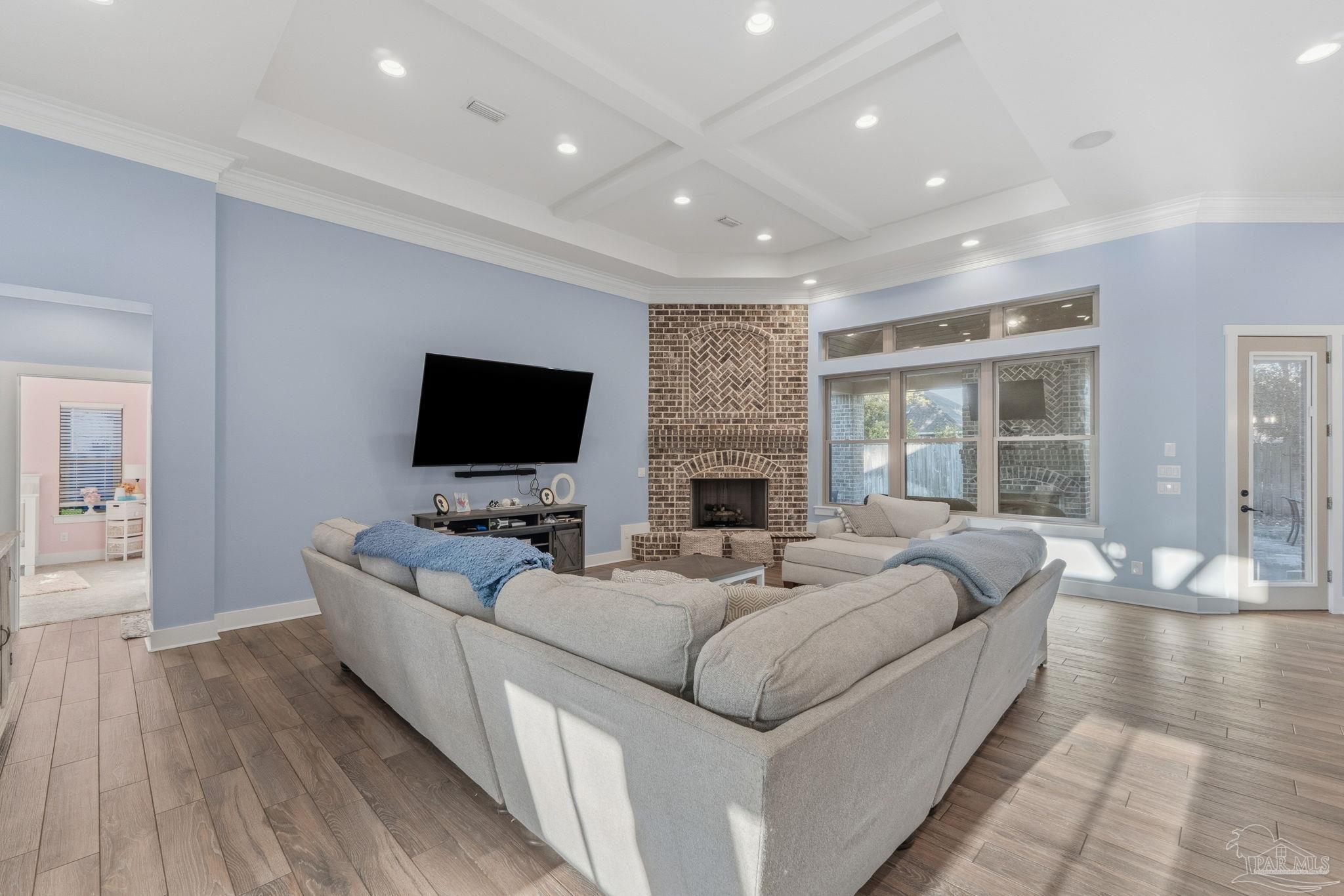 2018 Rambling Oaks Drive Cantonment, FL 32533 - Photo 17 of 64 a living room with furniture a flat screen tv and a fireplace