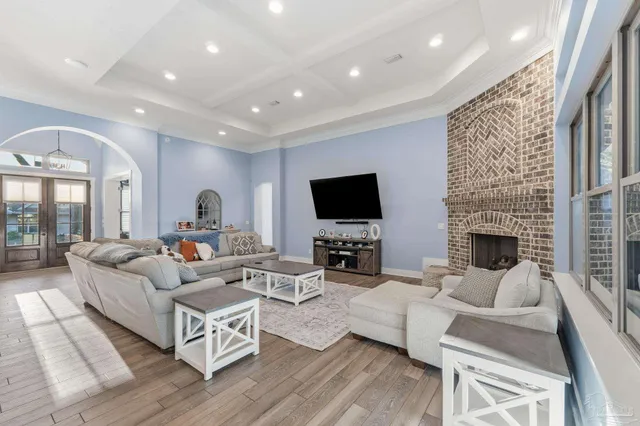 a view of a dining room with furniture a rug and wooden floor