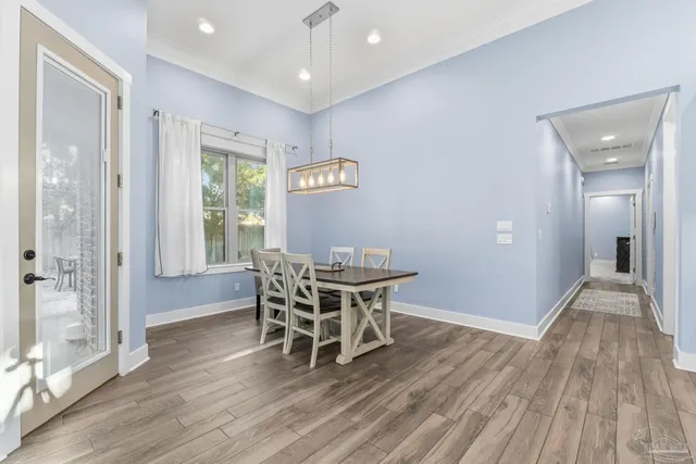 a kitchen with kitchen island granite countertop a kitchen island hardwood floor sink stove and refrigerator