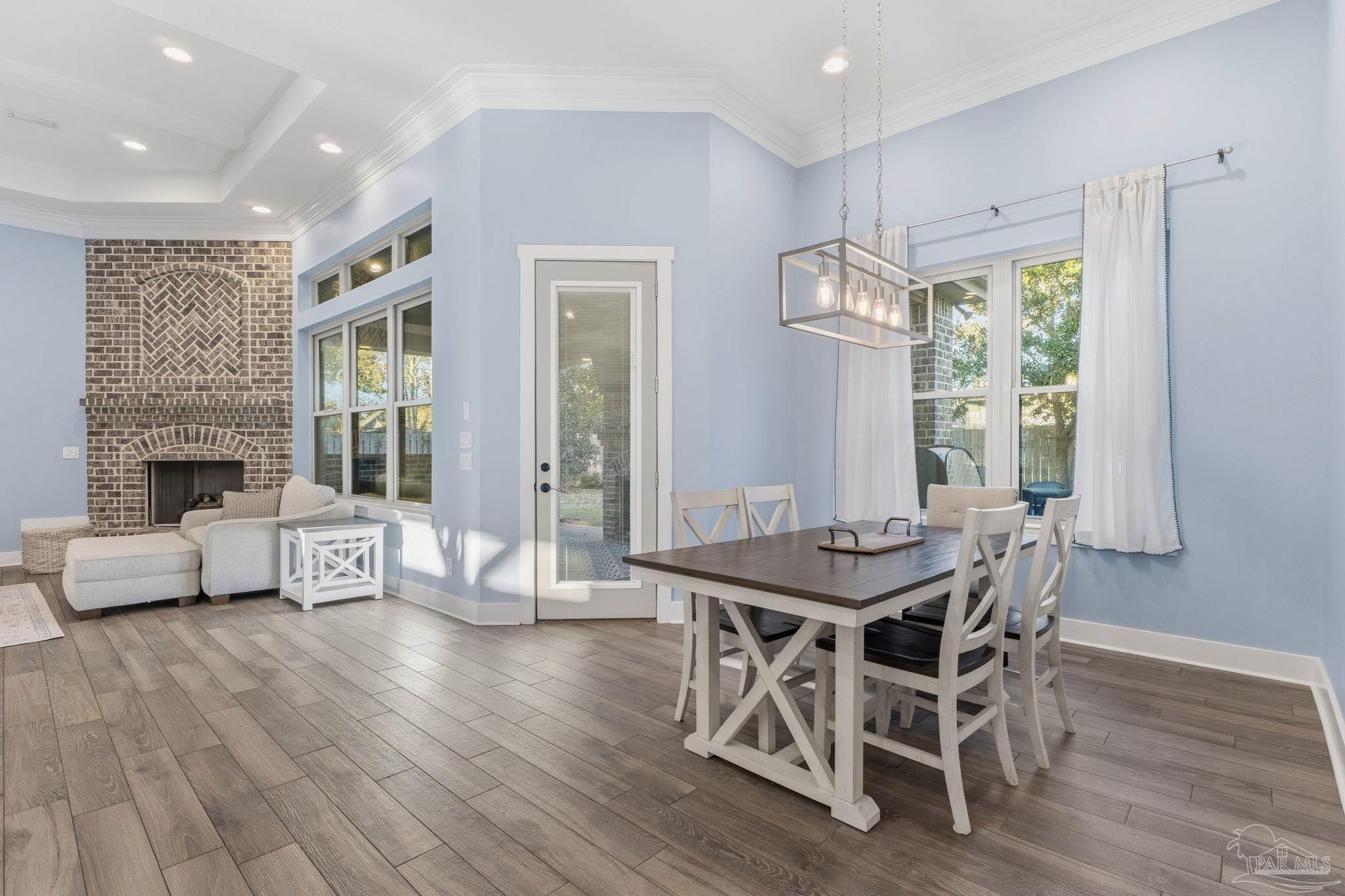 2018 Rambling Oaks Drive Cantonment, FL 32533 - Photo 21 of 64 a view of a dining room with furniture window and wooden floor