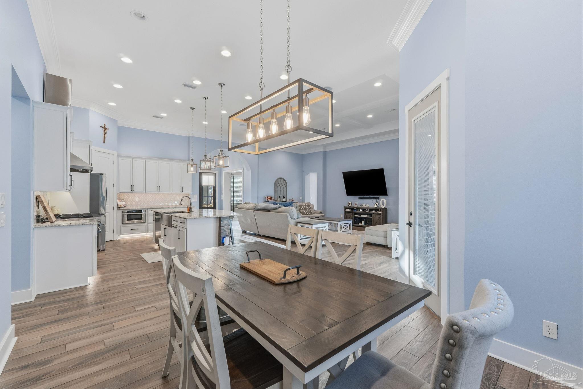 2018 Rambling Oaks Drive Cantonment, FL 32533 - Photo 22 of 64 a view of a dining room with furniture a rug and wooden floor